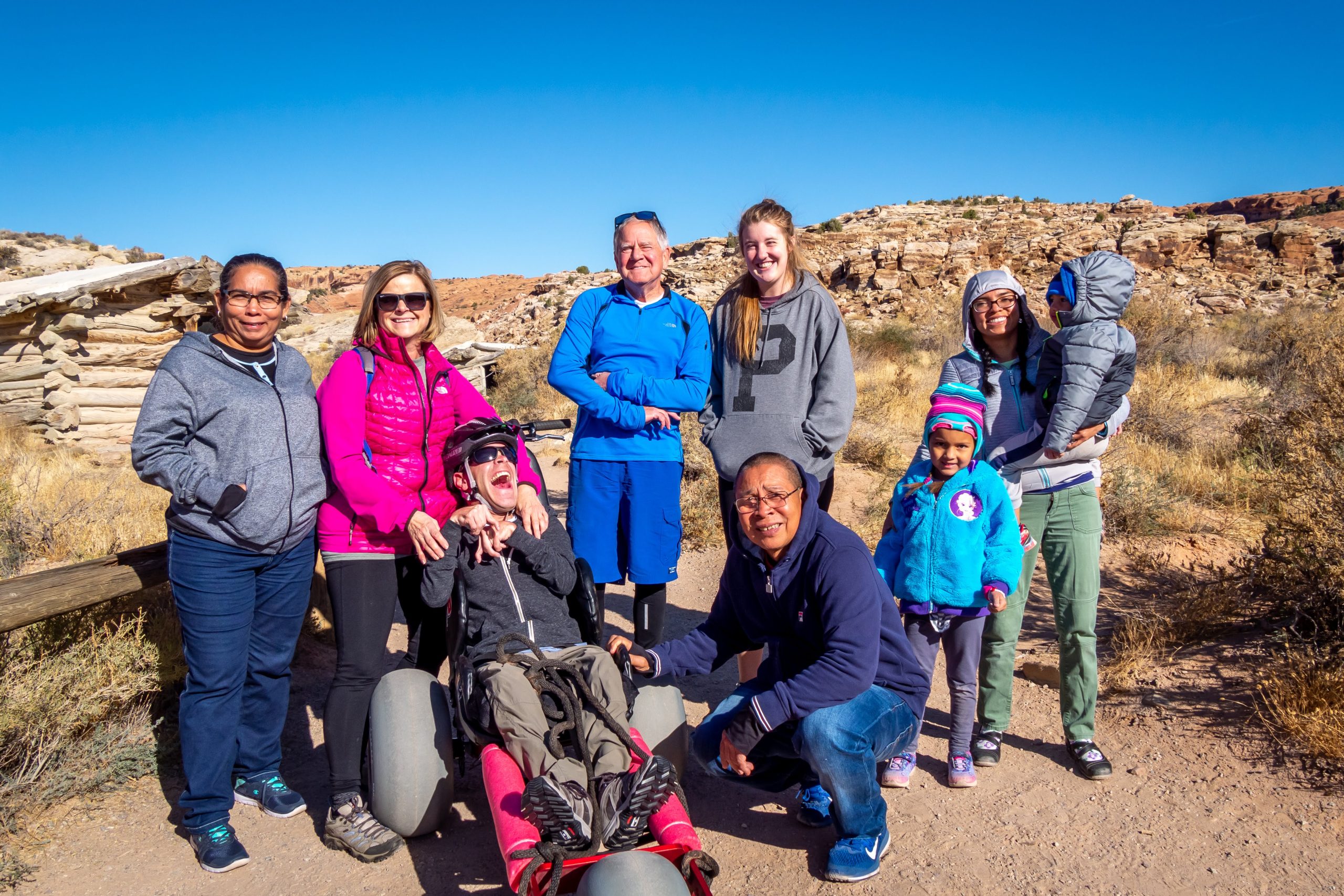 Family hiking together in Arches National Park with the Extreme Motus all terrain wheelchair