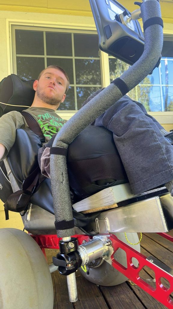 Communication device mounted to an Extreme Motus all terrain wheelchair.