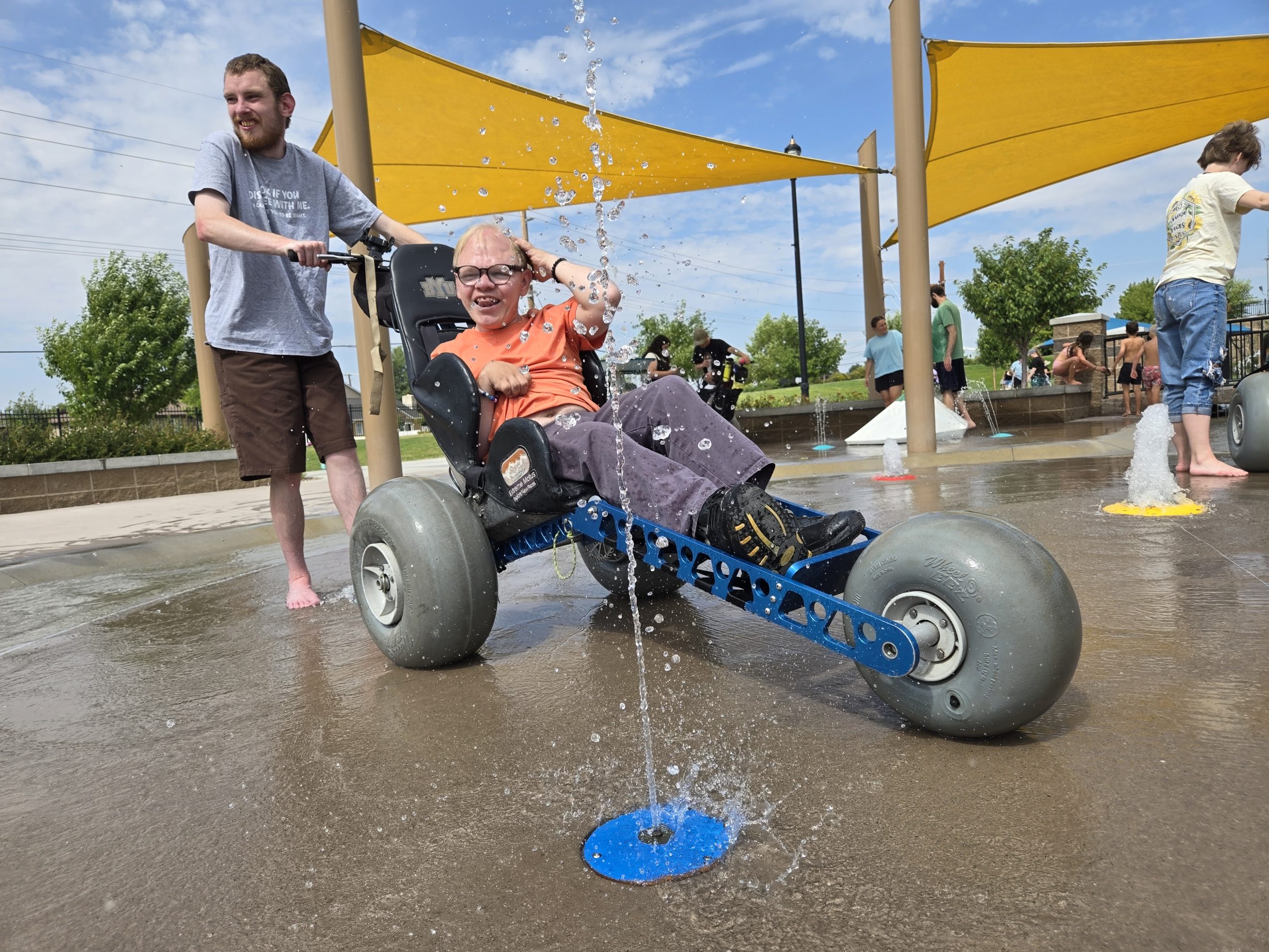 Fun at the splash pad in the Extreme Motus all terrain wheelchair.