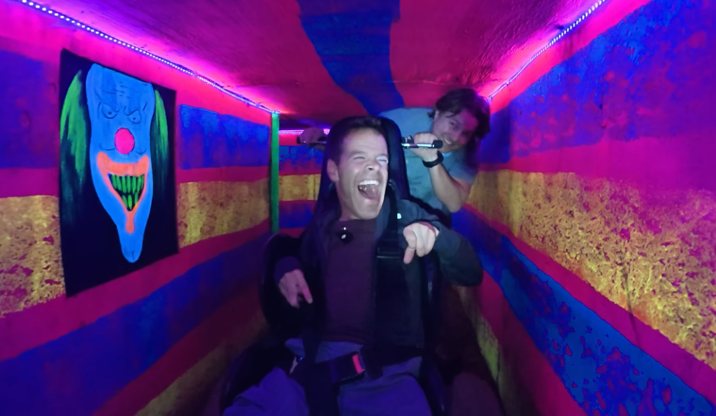 man with cerebral palsy having fun at a halloween haunted forest.
