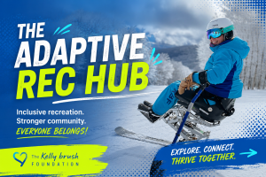 Smiling woman in a sit-ski mono-ski on a snowy mountain, promoting the Kelly Brush Foundation Adaptive Rec Hub.